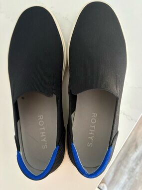 Rothy's  Women’s Black Original Slip-On Sneakers with the Signature Blue Trim
